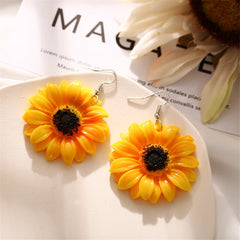 Yellow sunflower drop earrings featuring black centers, showcasing a vibrant floral design.