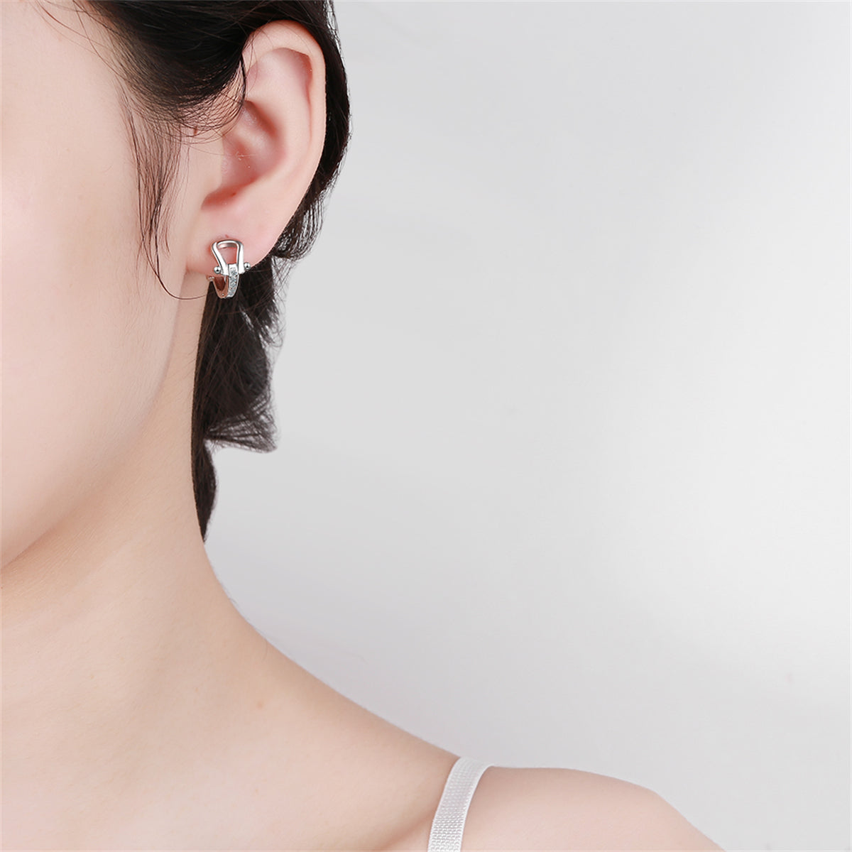 Cubic Zirconia and Silver-Plated Vachette Clasp Huggie Earrings, silver huggie earrings, detail close-up