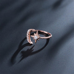 Bypass ring in rose gold plating, showcasing a star and moon design, enhanced with dazzling cubic zirconia gems.