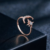 Rose gold-plated bypass ring featuring a star and moon design, adorned with sparkling cubic zirconia accents.