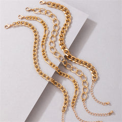 A set of four gold chain anklets, showcasing a luxurious 18K gold-plated curb chain for a trendy accessory.