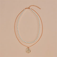 Layered necklace with an 18K gold-plated owl pendant, coin charm, and a stunning pearl chain for a refined look.