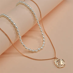 Elegant 18K gold-plated owl pendant necklace with a coin charm, complemented by a delicate pearl chain.