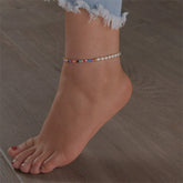 A vibrant stretch anklet featuring multicolor Howlite beads and elegant pearls, showcasing a playful yet sophisticated design.