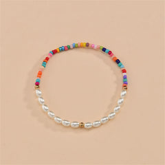 A colorful stretch anklet adorned with Howlite beads and pearls, blending vibrant hues for a stylish accessory.