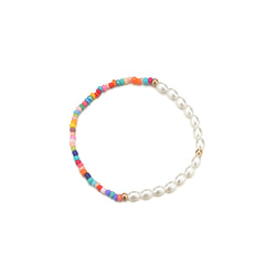 A charming stretch anklet featuring colorful Howlite beads and pearls, perfect for adding a pop of color to your ensemble.