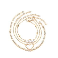 Three exquisite gold chains embellished with pearls and heart charms, alongside a chic 18K gold-plated tennis bracelet set.