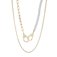 Elegant layered necklaces: one with a gold chain and the other a pearl necklace, featuring a gold handcuff pendant.