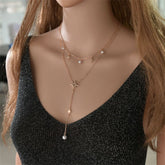 Gold star necklace featuring a star pendant adorned with two diamonds, crafted in 18K gold plating.