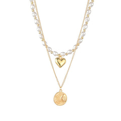 A chic necklace featuring a heart and sun coin in 18K gold plating, enhanced with lustrous pearls for added elegance.