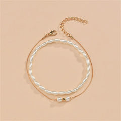 Elegant gold chain anklet adorned with a pearl and gold beads, included in a stunning 18K gold-plated anklet set.