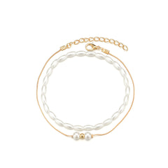 A refined gold chain anklet with a pearl and gold beads, elegantly crafted as part of an 18K gold-plated anklet set.