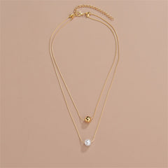 Elegant layered necklace showcasing two gold and white pearls, adorned with 18K gold-plated beads.