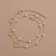 An elegant layered bracelet with a gold chain, pearls, and a circle charm, beautifully designed in 18K gold plating.