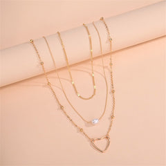 A sophisticated layered pendant necklace with an 18K gold-plated heart and a pearl, ideal for enhancing any outfit.