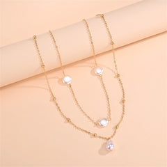 Elegant two-layer necklace with pearls and a gold chain, showcasing a refined style with 18K gold plating.