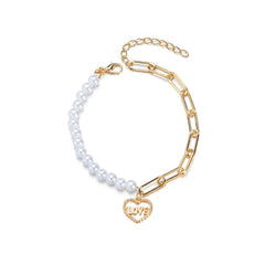 Elegant white pearl bracelet adorned with a gold heart charm, representing love and timeless beauty.