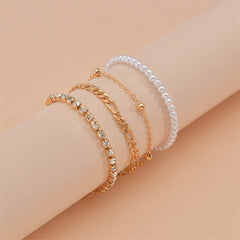 Three-strand gold chain anklet with pearls, showcasing sophistication as part of a four-piece beaded anklet collection.