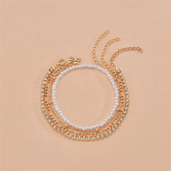 A stylish three-strand gold chain anklet embellished with pearls, belonging to a chic four-piece beaded anklet set.