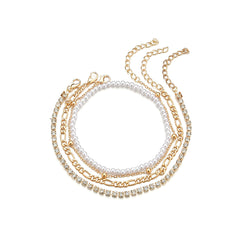 Three-strand gold chain anklet with pearls, elegantly designed as part of a four-piece beaded anklet set.