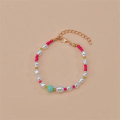 Elegant bracelet with pink and white beads, complemented by a gold chain, showcasing Howlite and Turquoise elements.