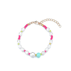 A chic bracelet composed of pink and white beads on a gold chain, featuring Howlite and Turquoise accents.