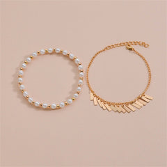 A sophisticated gold chain bracelet with white pearls, highlighting a luxurious gold chain detail.