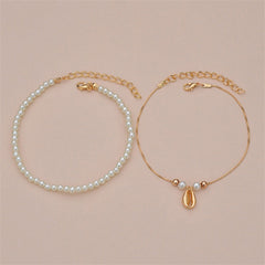 Two beautiful anklets combining pearls and gold chains, featuring a pearl and 18K gold-plated shell charm design.