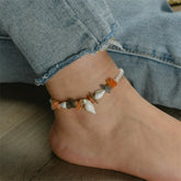 A stylish anklet featuring orange quartz and shell pearl stones, elegantly set in 18K gold plating.