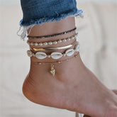 Three elegant gold and black anklets adorned with shells and pearls, showcasing a luxurious 18K gold-plated design.