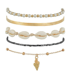 An elegant trio of gold and black anklets with shells and pearls, representing a sophisticated 18K gold-plated anklet collection.