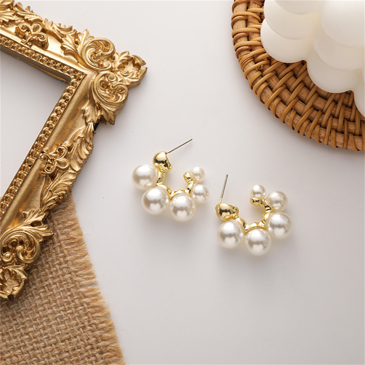 Elegant pearl cluster earrings featuring 18K gold-plated C-shape huggies for a chic and sophisticated look.