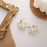 Elegant pearl cluster earrings featuring 18K gold-plated C-shape huggies for a chic and sophisticated look.