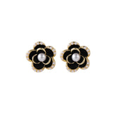 Elegant black and white flower earrings featuring diamonds, crafted in 18k gold-plated with pearl and black enamel accents.