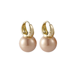 Elegant peach pearl huggie earrings, featuring 18K gold plating for a chic and stylish look.