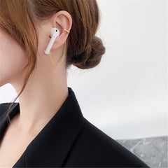 Elegant gold-plated earring with a pearl centerpiece and crisscross design, enhanced by cubic zirconia.