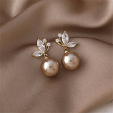 Stunning champagne pearl earrings with a butterfly design, embellished with white pearls and cubic zirconia.