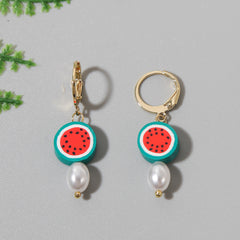 Stunning watermelon pearl drop earrings crafted from polymer clay and 18K gold-plated for a chic and vibrant accessory.