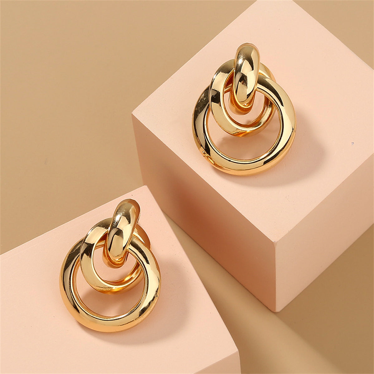 Elegant 18K gold-plated drop earrings featuring a stylish circular design, perfect for any occasion.