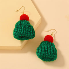 Two knitted hats in green and red with pom poms, designed for a cheerful Christmas look.