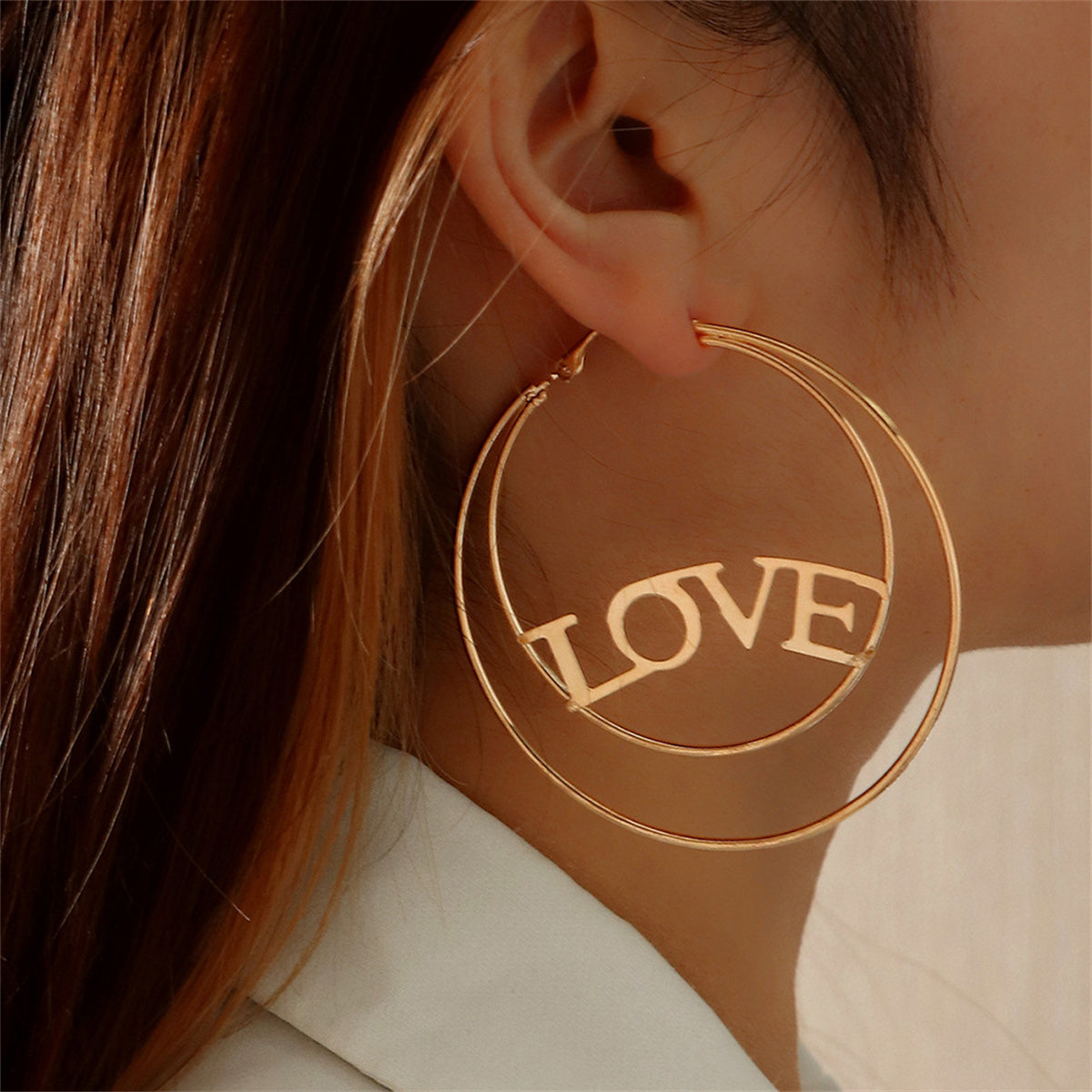 Elegant 18K gold-plated hoop earrings featuring an openwork 'Love' design, perfect for expressing your affection.