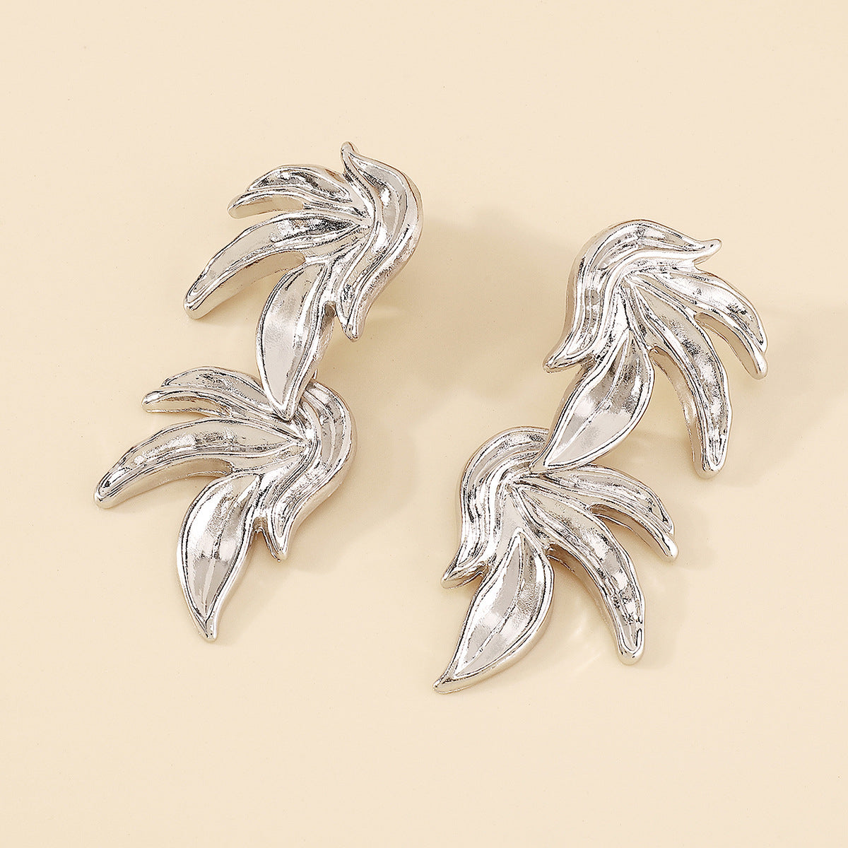 Silver-Plated Linked Leaves Drop Earrings, silver drop earrings for women, vintage-inspired design, styled look