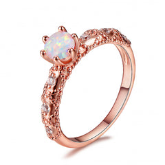 Stunning rose gold-plated solitaire ring with a vibrant opal stone and shimmering cubic zirconia details.