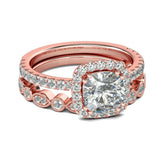 Rose gold engagement ring featuring a cushion-cut diamond surrounded by a halo of cubic zirconia and a matching band.