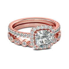 Rose gold engagement ring featuring a cushion-cut diamond surrounded by a halo of cubic zirconia and a matching band.
