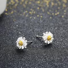 Charming white daisy stud earrings with yellow centers, crafted from 18K gold-plated sterling silver for a touch of elegance.