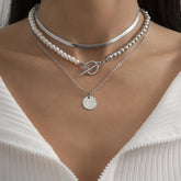 Three layered necklaces featuring a pendant and a silver chain, part of the Pearl & Silver-Plated Toggle Necklace Set.