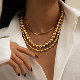 Elegant 18K gold-plated necklace featuring beads and a sleek snake chain, perfect for any stylish occasion.