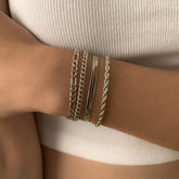 Four silver-plated bracelets featuring a Figaro chain design with a secure clasp, elegantly displayed together.