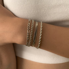 Four silver-plated bracelets featuring a Figaro chain design with a secure clasp, elegantly displayed together.